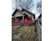 Side view of a one-story house with a chain link fence at 1154 N Belleview Pl, Indianapolis, IN 46222