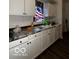 White kitchen cabinets and marble-look countertops at 1154 N Belleview Pl, Indianapolis, IN 46222