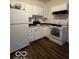White kitchen with appliances and dark floors at 1154 N Belleview Pl, Indianapolis, IN 46222