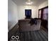 Simple living room with brown couch and dark wood floors at 1154 N Belleview Pl, Indianapolis, IN 46222