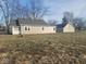 View of the back exterior featuring gray siding and a large yard at 1510 Josephine St, Martinsville, IN 46151