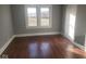 Bedroom features gleaming hardwood floors and a bright window for natural light at 1510 Josephine St, Martinsville, IN 46151