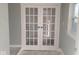 Elegant entryway featuring double doors, gray walls, and a window for natural light at 1510 Josephine St, Martinsville, IN 46151