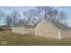 View of the house and detached garage with neutral siding, complemented by an expansive lawn at 1510 Josephine St, Martinsville, IN 46151