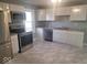 Modern kitchen featuring stainless steel appliances, gray countertop, and white cabinets at 1510 Josephine St, Martinsville, IN 46151