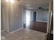 Living room view featuring grey walls, ceiling fan, doorway, and hardwood floor at 1510 Josephine St, Martinsville, IN 46151