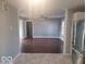View of a well-lit living room with hardwood floors, leading into a kitchen area at 1510 Josephine St, Martinsville, IN 46151