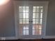 Living room featuring wood floors with glass panel double doors with views to another room at 1510 Josephine St, Martinsville, IN 46151