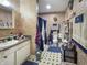 A compact bathroom with a pedestal sink, patterned wallpaper, and coordinated blue accents at 1515 Ringgold Ave, Indianapolis, IN 46203