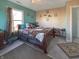 This bedroom features a queen size bed and ample natural light through the window at 1515 Ringgold Ave, Indianapolis, IN 46203