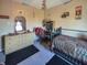 A bedroom featuring a bed, dresser, desk, and a small window at 1515 Ringgold Ave, Indianapolis, IN 46203