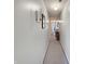 The hallway features neutral paint and carpet and wall sconces and leads to the bedrooms at 1515 Ringgold Ave, Indianapolis, IN 46203