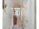 The hallway features neutral paint and carpet and leads to the bedrooms and other rooms at 1515 Ringgold Ave, Indianapolis, IN 46203