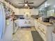 A bright kitchen featuring white appliances, cabinets and countertops, complemented by decorative sunflower accents at 1515 Ringgold Ave, Indianapolis, IN 46203