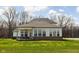 Spacious backyard view of home with covered patio and exterior brick accents at 16012 Forewood Ln, Fishers, IN 46037
