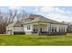 Backyard with covered porch, white siding, brick accents, and a view of lawn at 16012 Forewood Ln, Fishers, IN 46037