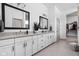 Modern bathroom featuring double sinks, granite countertops, white cabinetry, and a walk-in closet at 16012 Forewood Ln, Fishers, IN 46037