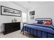 Bedroom with a dark blue comforter, sports memorabilia, and a black dresser at 16012 Forewood Ln, Fishers, IN 46037