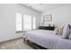 Bedroom with a light purple comforter, a view of the backyard, and a wooden dresser at 16012 Forewood Ln, Fishers, IN 46037