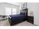 Bedroom with blue comforter, wooden furniture and walls decorated with sports memorabilia at 16012 Forewood Ln, Fishers, IN 46037