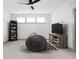 A bonus room with a large beanbag, a tv, and a bookcase at 16012 Forewood Ln, Fishers, IN 46037