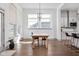 Sunlit dining area featuring a wooden table, modern lighting, and large windows at 16012 Forewood Ln, Fishers, IN 46037