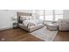 Bright main bedroom with a neutral palette, a large window for natural light, and a cozy sitting area at 16012 Forewood Ln, Fishers, IN 46037