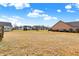 Wide backyard with a large grassy lawn and a view of the neighboring residential homes at 16457 Anderson Way, Noblesville, IN 46062