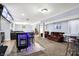 Finished basement with a sleek bar, multiple TVs, seating and open staircase at 16457 Anderson Way, Noblesville, IN 46062