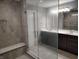 Well-lit bathroom with glass shower, bench, tiled walls, and vanity with sink at 16457 Anderson Way, Noblesville, IN 46062