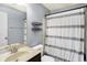 Bathroom with a shower featuring a striped curtain and a vanity with a white sink at 16457 Anderson Way, Noblesville, IN 46062