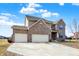 Charming two-story brick home featuring a three-car garage and manicured landscaping at 16457 Anderson Way, Noblesville, IN 46062