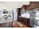 Stylish kitchen with stainless steel appliances, dark wood cabinets, and granite countertops at 16457 Anderson Way, Noblesville, IN 46062