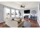 Bright living room featuring a fireplace, large windows, and modern decor at 16457 Anderson Way, Noblesville, IN 46062