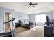 Main bedroom featuring a large bed, vaulted ceiling, ceiling fan, and adjacent bathroom at 16457 Anderson Way, Noblesville, IN 46062