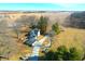 An aerial view shows the property's buildings and long driveway to the home surrounded by a field at 22351 Cyntheanne Rd, Noblesville, IN 46060