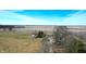Aerial view of a farm with outbuildings, barns, fields, and a home surrounded by trees at 22351 Cyntheanne Rd, Noblesville, IN 46060