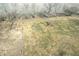 Aerial view of a field surrounded by trees and a fence line under a clear sky at 22351 Cyntheanne Rd, Noblesville, IN 46060