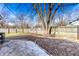Spacious backyard with a mature tree, a concrete patio, and a gravel area for outdoor enjoyment at 3144 Voigt Dr, Indianapolis, IN 46224