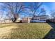 Expansive backyard featuring a shed, complemented by a well-maintained lawn and mature trees at 3144 Voigt Dr, Indianapolis, IN 46224