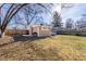 Large backyard featuring a shed, and a well-maintained lawn, bordered by a wooden fence at 3144 Voigt Dr, Indianapolis, IN 46224