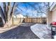 Landscaped backyard featuring a fenced perimeter, mature tree, and a mix of patio surfaces at 3144 Voigt Dr, Indianapolis, IN 46224