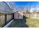 View of backyard with shed and partial grass coverage, enclosed by a wooden fence at 3144 Voigt Dr, Indianapolis, IN 46224