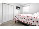 Bedroom featuring a queen bed with heart bedding, a wall mounted television and an ample closet at 3144 Voigt Dr, Indianapolis, IN 46224