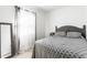 Bedroom with a gray bed frame, patterned bedding, and a mirrored side table, offering a relaxing atmosphere at 3144 Voigt Dr, Indianapolis, IN 46224