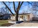 Tan ranch home with large tree in front yard; short, covered porch; and driveway at 3144 Voigt Dr, Indianapolis, IN 46224