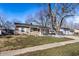 Charming tan ranch home with a tidy front yard and a mature tree providing shade at 3144 Voigt Dr, Indianapolis, IN 46224