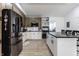 Modern kitchen featuring stainless steel appliances, white cabinets, and a contrasting black island at 3144 Voigt Dr, Indianapolis, IN 46224