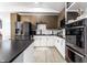 This modern kitchen has stainless steel appliances, black countertops, and white and wood cabinets at 3144 Voigt Dr, Indianapolis, IN 46224