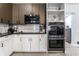 This kitchen features stainless steel double ovens, a built-in microwave and sleek white and wood cabinets at 3144 Voigt Dr, Indianapolis, IN 46224